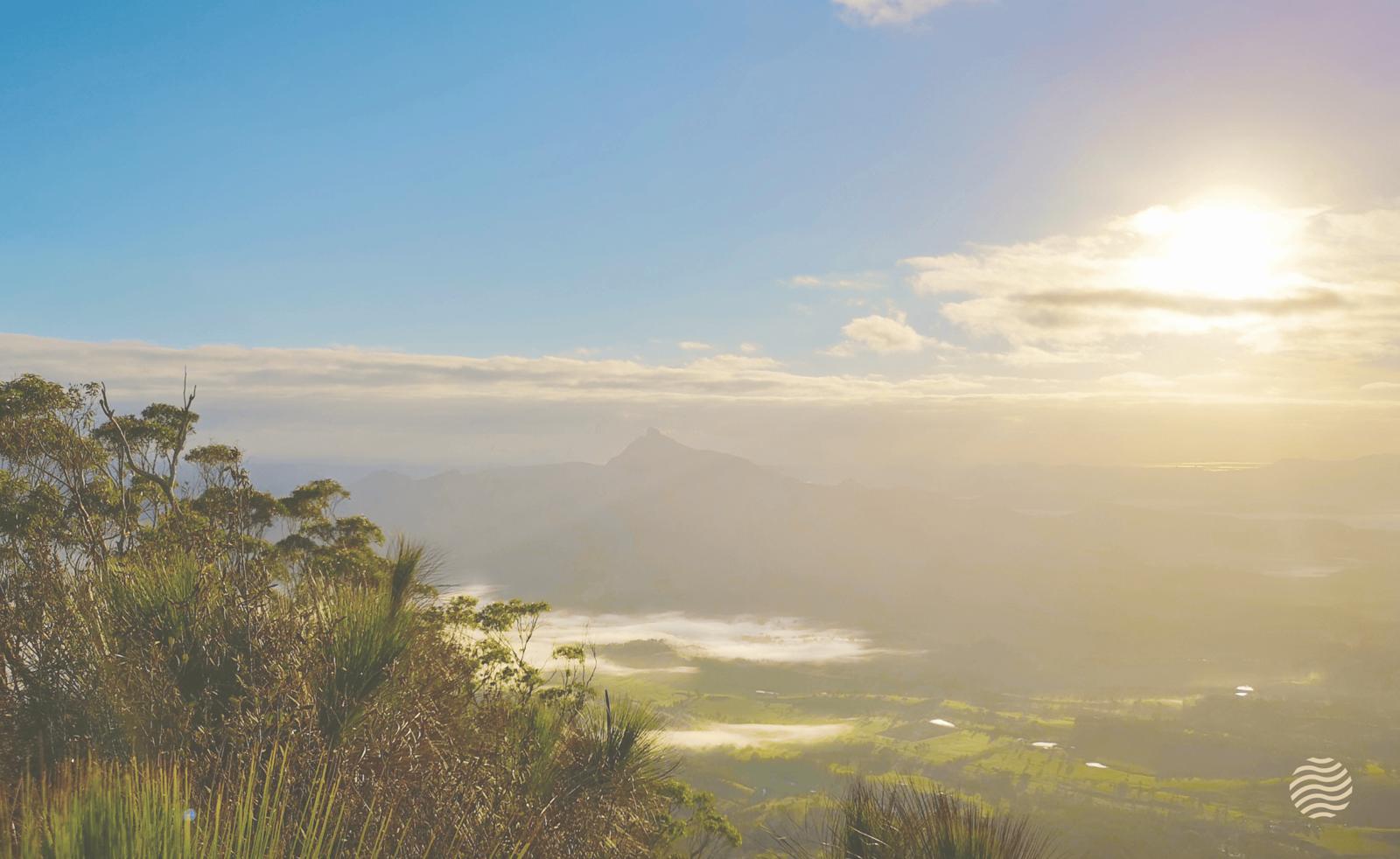 Sunrise over the Northern Rivers valley and mountains, with the Osprey wave mark in the corner